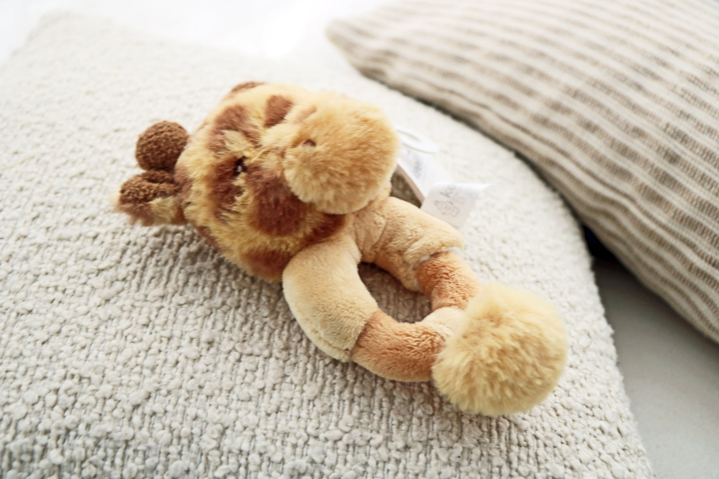 14cm Keeleco Huggy Giraffe Ring Rattle on white background. Newborn toy rattle for babies.