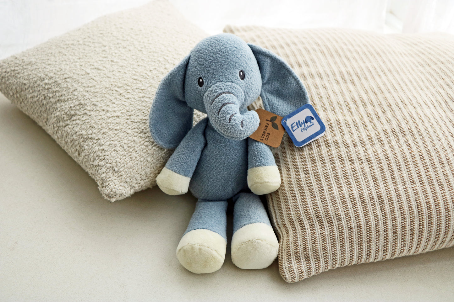 Elly Elephant Plush 14" on neutral cushions background. Newborn baby soft toy plush for babies.