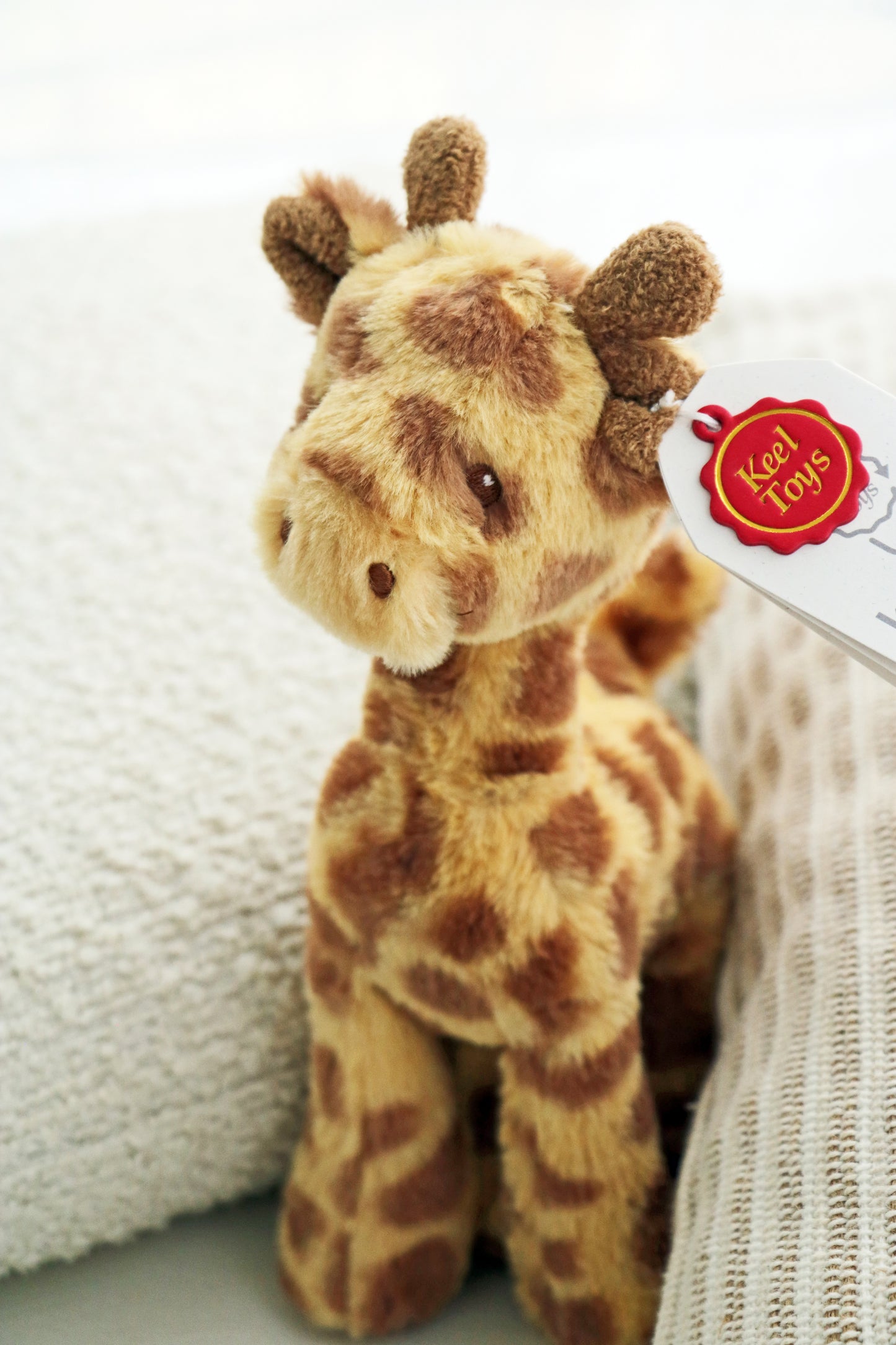 Keeleco Huggy Giraffe (17cm) plush soft soft for babies and newborn. Teddy stuffed animal on white background.