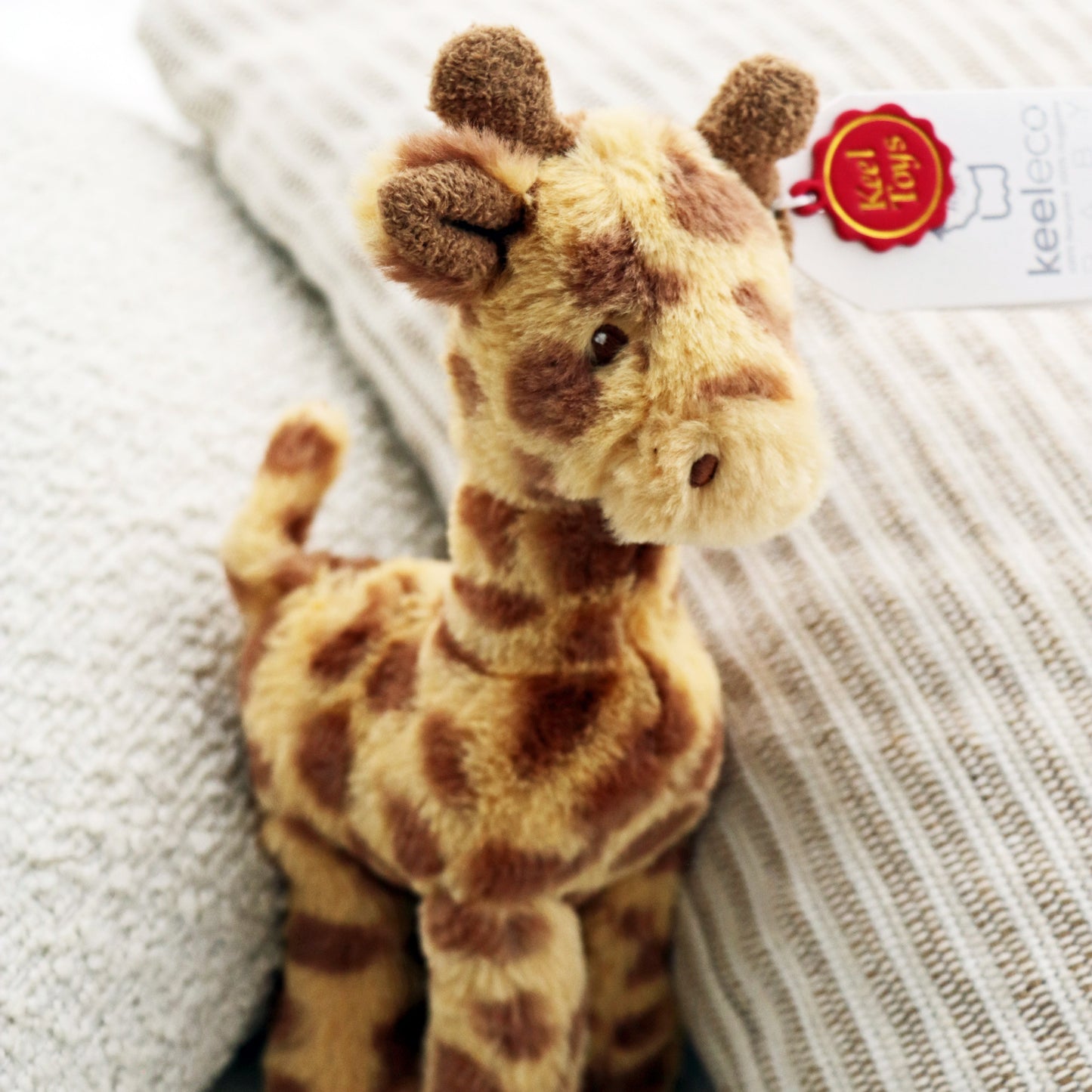 Keeleco Huggy Giraffe (17cm) plush soft soft for babies and newborn. Teddy stuffed animal on white background.