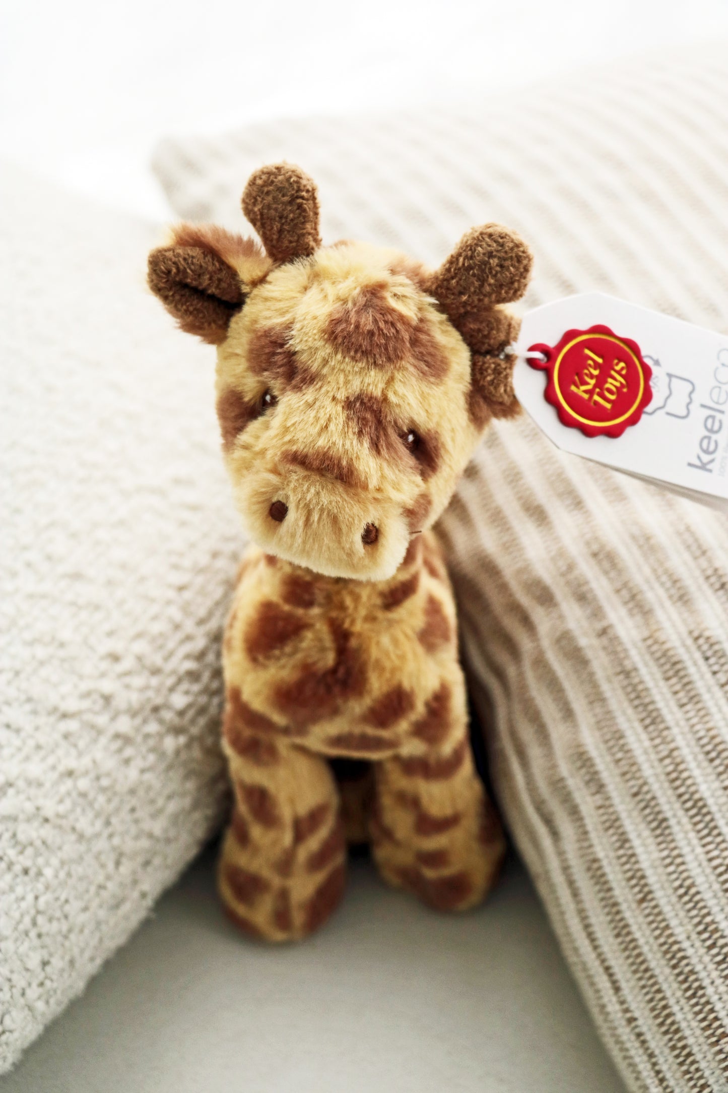 Keeleco Huggy Giraffe (17cm) plush soft soft for babies and newborn. Teddy stuffed animal on white background.