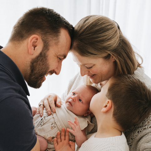 Family photo of Mum, Dad, son and daughter. Baby girl. toddler