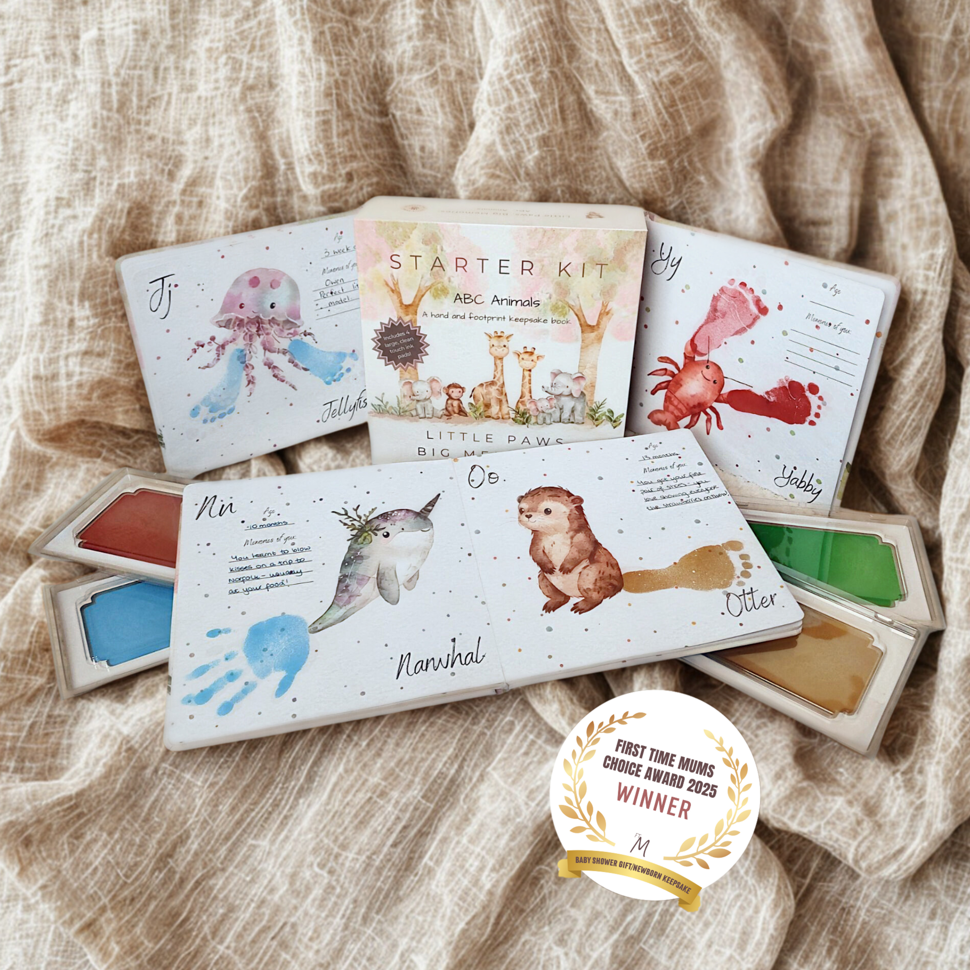 ABC Animals Baby Handprint and footprint memory book on linen cloth background. 'First time Mums Choice Award 2025, Best Baby Gift / Keepsake Winner'. 