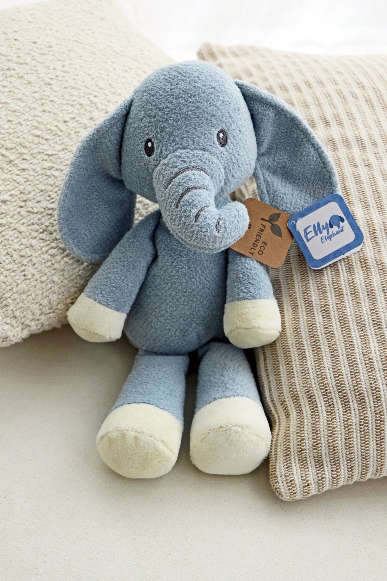 Elly Elephant Plush 14" on neutral cushions background. Newborn baby soft toy plush for babies.