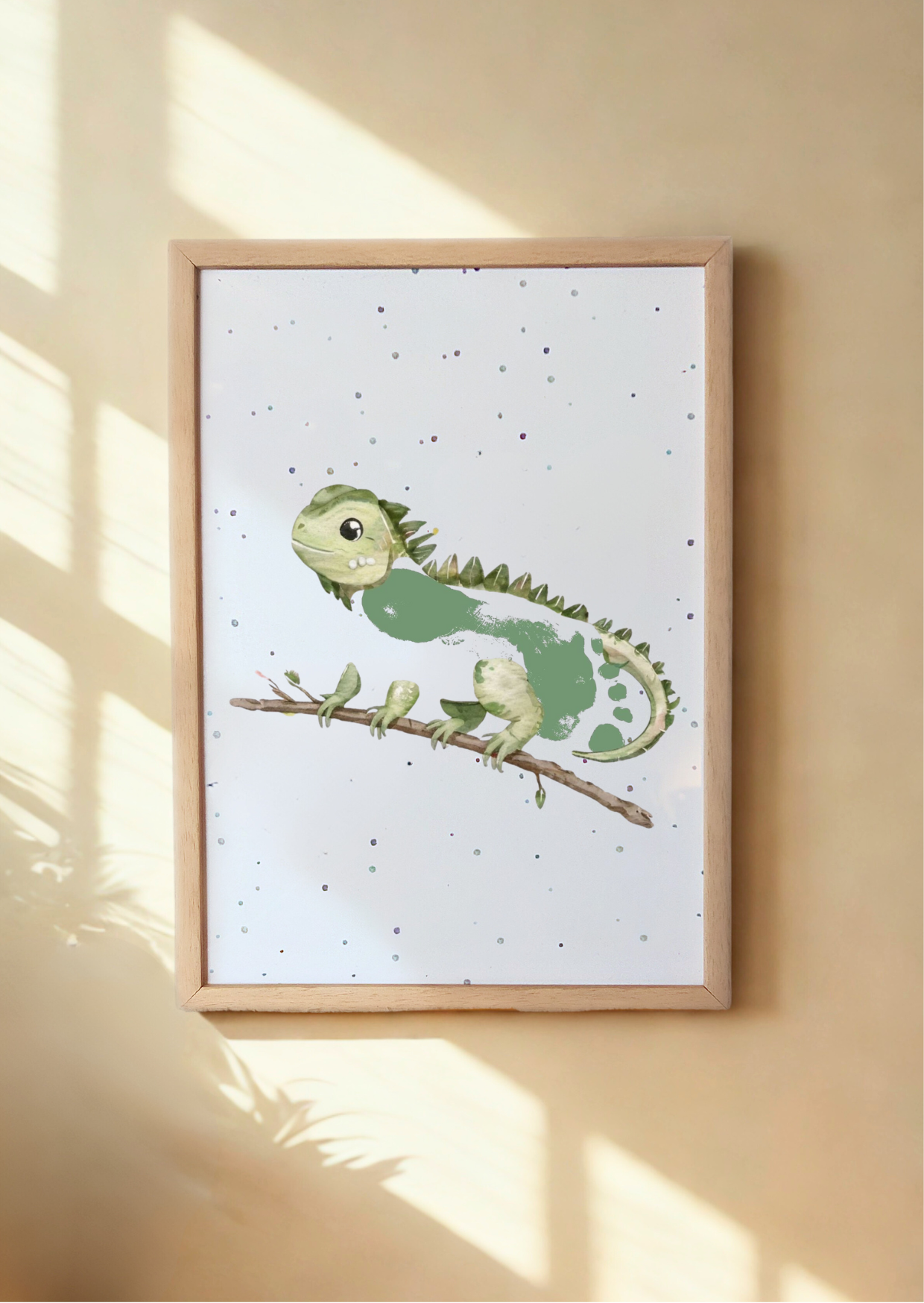 Framed print of iguana with child's footprint as its body
