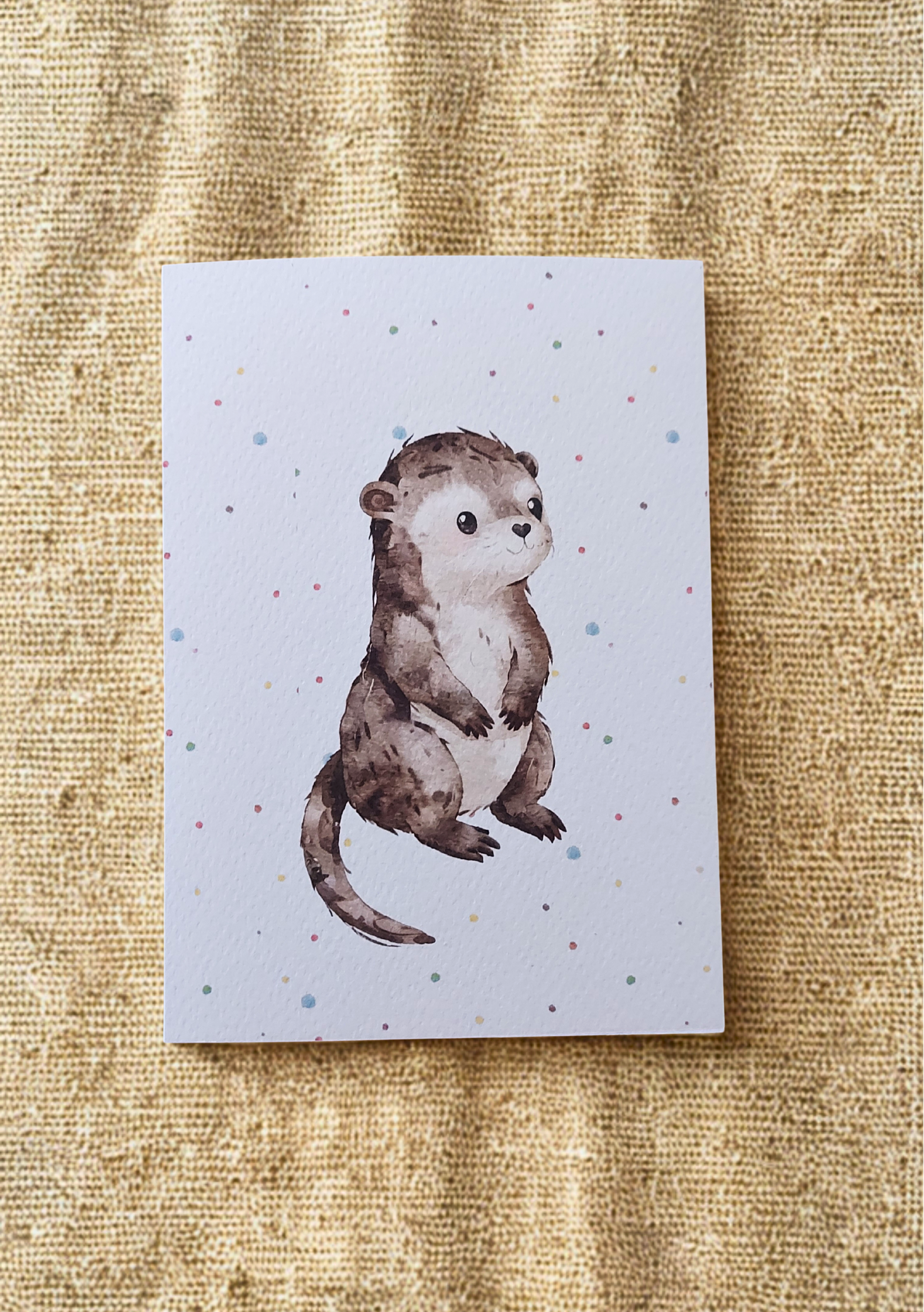 Greetings Card - Watercolour Otter. Blank inside. On plain linen cloth background.