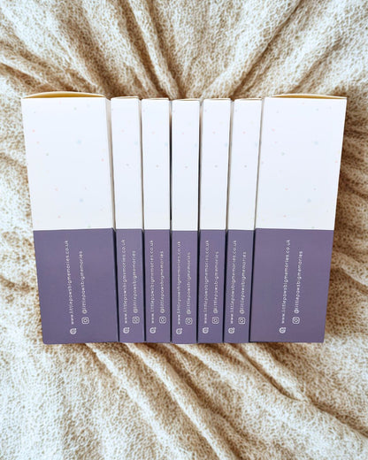 Set of six ink pad boxes on a textured beige surface