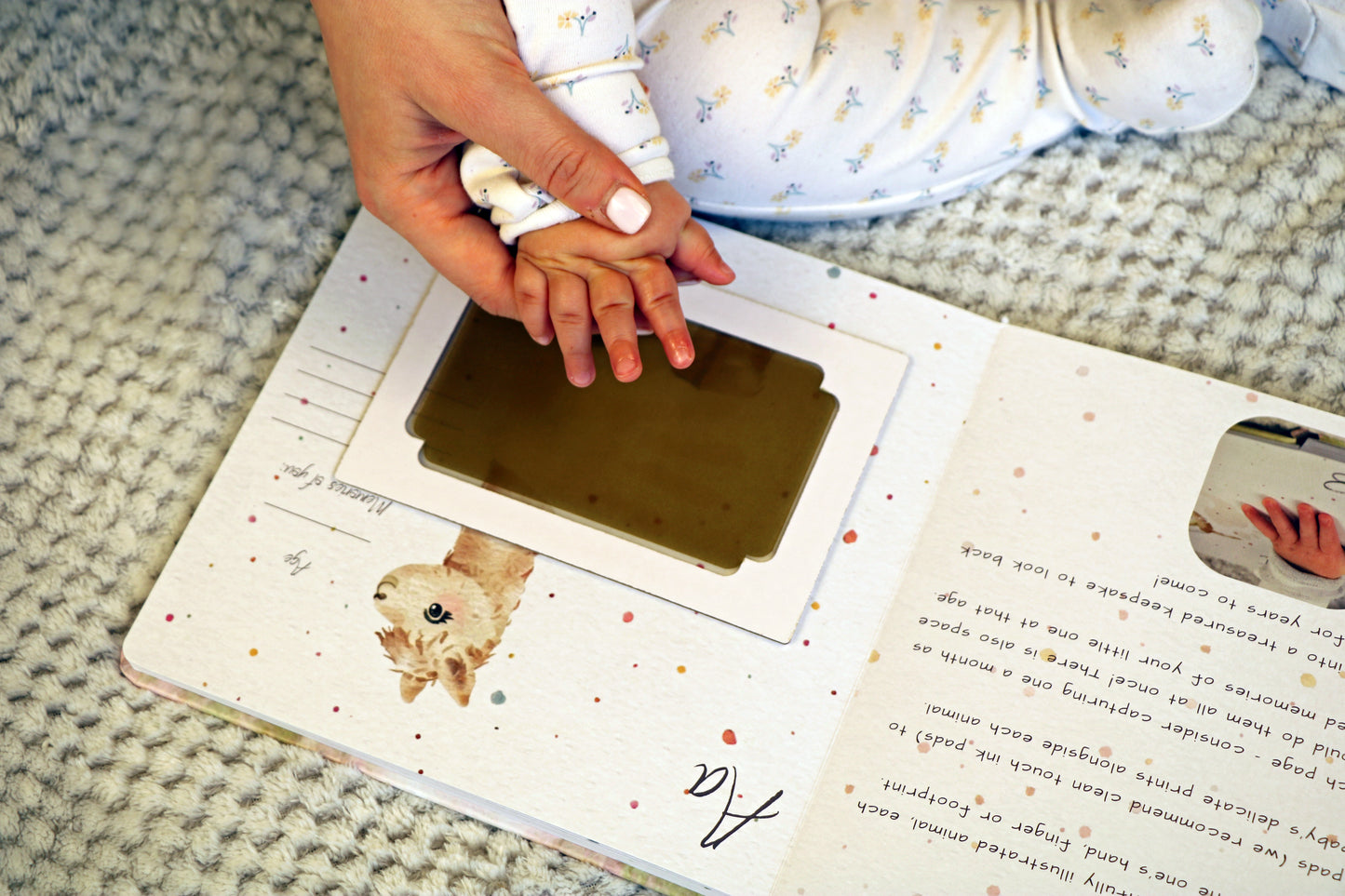 Little Paws Big Memories ABC Animals Alpaca Page with Baby Handprint and clean touch ink pad in brown. Mum helping baby take handprint. Newborn baby gift idea, baby shower gift idea.