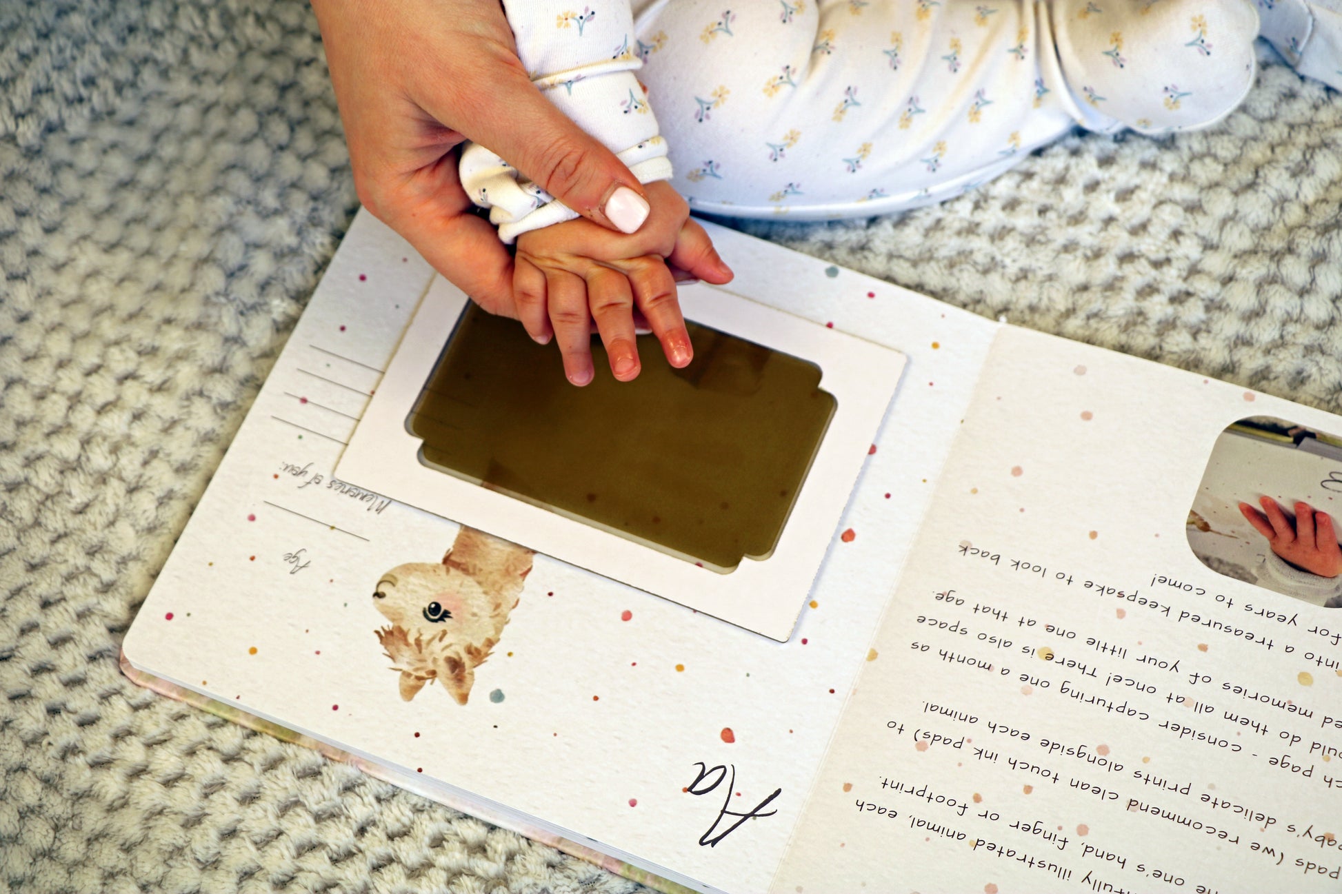 Little Paws Big Memories ABC Animals Alpaca Page with Baby Handprint and clean touch ink pad in brown. Mum helping baby take handprint. Newborn baby gift idea, baby shower gift idea.