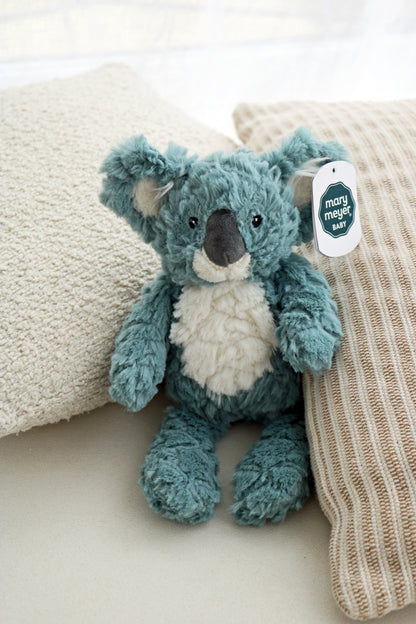 Mary Meyer Putty Koala soft toy plush for babies and newborn on neutral cushions background. mary meyer putty nursery stuffed animal soft toy 11-inches slate blue koala