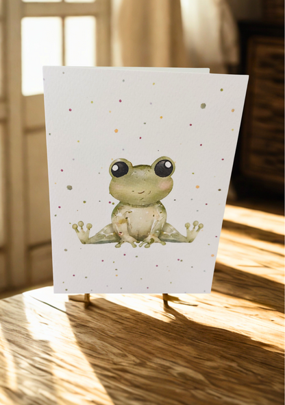 Greetings Card - Watercolour Frog. Blank inside. On wooden table with warm sunlight.