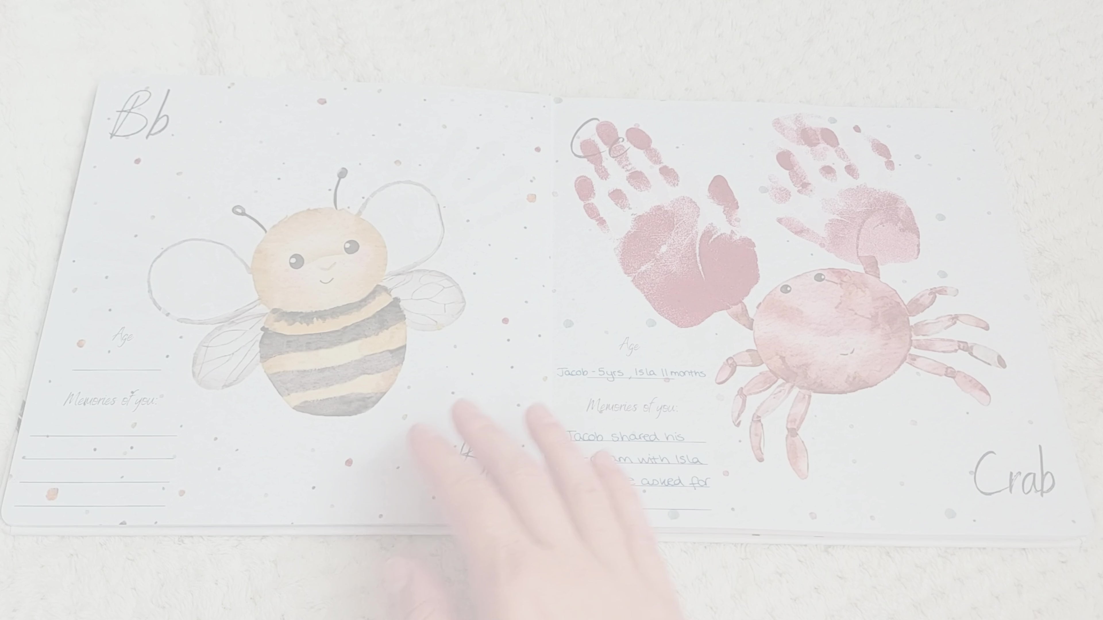 Load video: Little Paws Big Memories ABC Animals. Video showing the book, handprints and footprints in the book, book features, clean touch ink pads, baby footprint, baby handprint, luxury magnetic gift box, thick quality pages, layflat design making it easy to take and dry prints. Capture precious memories before your baby grows.